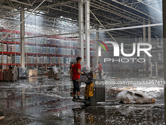 Workers are removing the debris in a warehouse damaged by a Russian missile strike in Odesa, Ukraine, on June 24, 2024. NO USE RUSSIA. NO US...