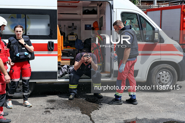 A firefighter is receiving first aid after putting out a fire at a warehouse caused by a Russian missile attack on civilian infrastructure i...