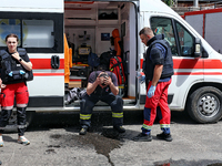 A firefighter is receiving first aid after putting out a fire at a warehouse caused by a Russian missile attack on civilian infrastructure i...