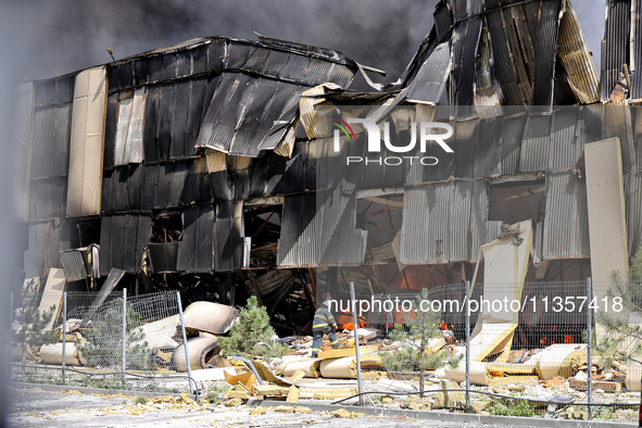 A firefighter is working to suppress a fire at a warehouse caused by a Russian missile strike in Odesa, Ukraine, on June 24, 2024. NO USE RU...