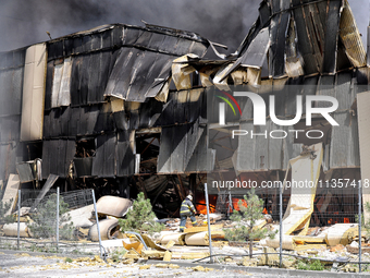 A firefighter is working to suppress a fire at a warehouse caused by a Russian missile strike in Odesa, Ukraine, on June 24, 2024. NO USE RU...