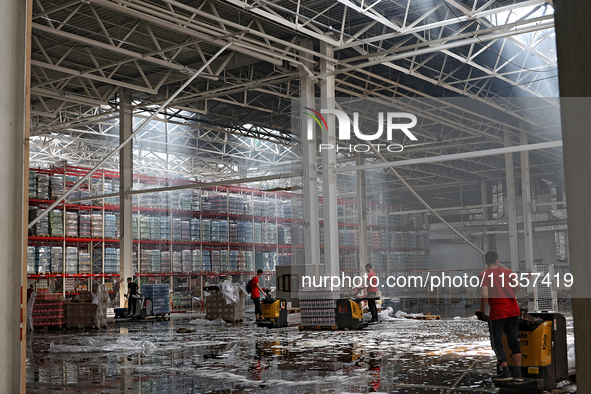 Workers are removing the debris in a warehouse damaged by a Russian missile strike in Odesa, Ukraine, on June 24, 2024. NO USE RUSSIA. NO US...