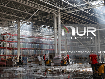 Workers are removing the debris in a warehouse damaged by a Russian missile strike in Odesa, Ukraine, on June 24, 2024. NO USE RUSSIA. NO US...