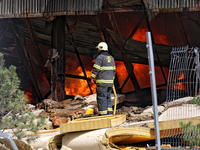 A firefighter is working to suppress a fire at a warehouse caused by a Russian missile strike in Odesa, Ukraine, on June 24, 2024. NO USE RU...