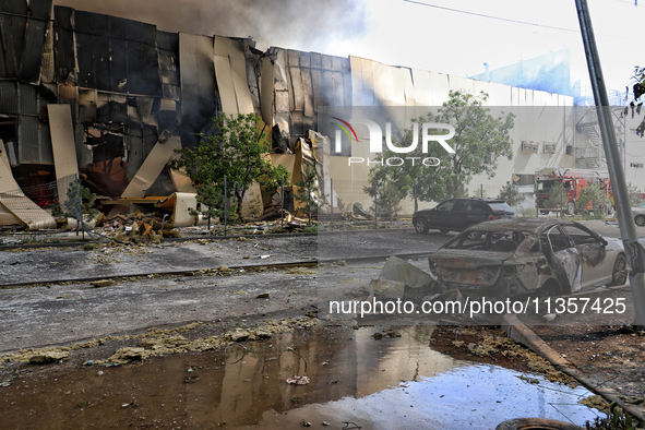 A destroyed car is being pictured outside a warehouse destroyed by a Russian missile attack in Odesa, Ukraine, on June 24, 2024. NO USE RUSS...