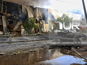 A destroyed car is being pictured outside a warehouse destroyed by a Russian missile attack in Odesa, Ukraine, on June 24, 2024. NO USE RUSS...