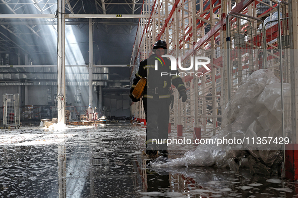 A firefighter is being seen inside a warehouse damaged by a Russian missile strike in Odesa, Ukraine, on June 24, 2024. NO USE RUSSIA. NO US...