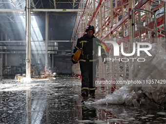 A firefighter is being seen inside a warehouse damaged by a Russian missile strike in Odesa, Ukraine, on June 24, 2024. NO USE RUSSIA. NO US...