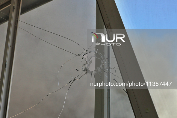 A hole in a windowpane is being pictured in an apartment building after a Russian missile attack on civilian infrastructure in Odesa, Ukrain...