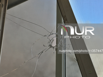 A hole in a windowpane is being pictured in an apartment building after a Russian missile attack on civilian infrastructure in Odesa, Ukrain...