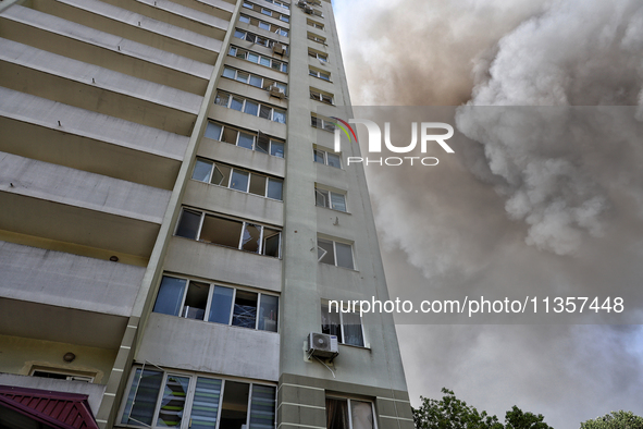 Smoke is rising from a civilian infrastructure facility damaged by a Russian missile attack near an apartment building in Odesa, Ukraine, on...