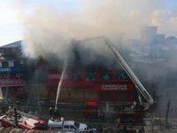 Indian firefighters and civilians are working to extinguish a fire in Srinagar, Jammu and Kashmir, on June 24, 2024. A mosque and some build...