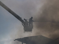 Indian firefighters are working to extinguish a fire in Srinagar, Jammu and Kashmir, on June 24, 2024. A mosque and some buildings are being...