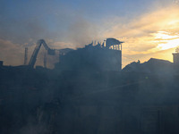 Indian firefighters and civilians are working to extinguish a fire in Srinagar, Jammu and Kashmir, on June 24, 2024. A mosque and some build...