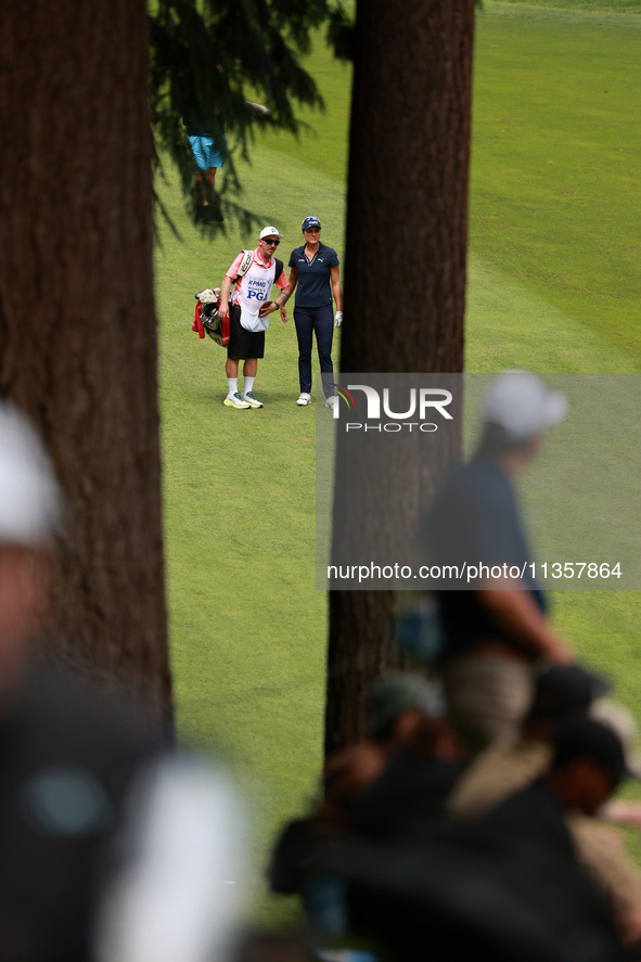 Lexi Thompson of the United States interacts with her caddy on the 16th hole during Day Four of the KPMG Women's PGA Championship at Sahalee...