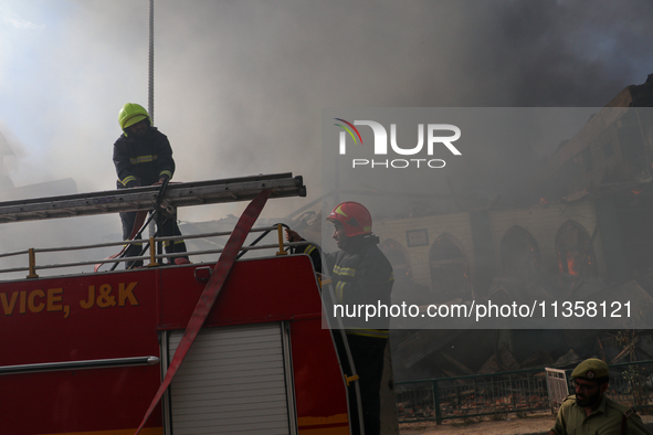 Firefighters are preparing to douse the fire in a congested neighborhood in Old City Srinagar, Indian Administered Kashmir, on June 24, 2024...