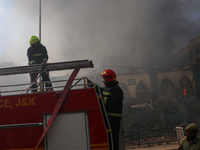 Firefighters are preparing to douse the fire in a congested neighborhood in Old City Srinagar, Indian Administered Kashmir, on June 24, 2024...