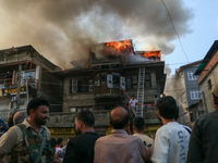 Local people are trying to douse the fire in a congested neighborhood in Old City Srinagar, Indian Administered Kashmir, on June 24, 2024. S...