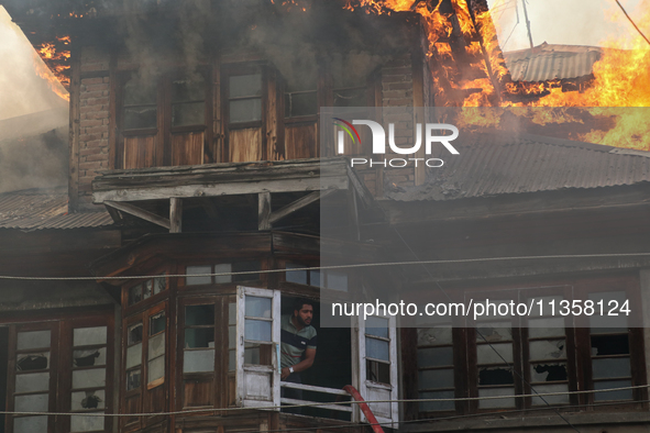 A fire is engulfing a residential house in a congested neighborhood in Old City Srinagar, Indian Administered Kashmir, on June 24, 2024. Sev...