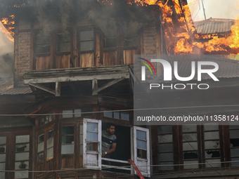 A fire is engulfing a residential house in a congested neighborhood in Old City Srinagar, Indian Administered Kashmir, on June 24, 2024. Sev...