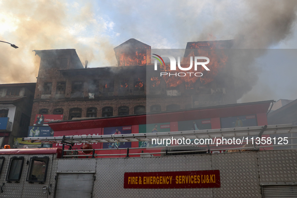 A house is engulfing in fire in a congested neighborhood in Old City Srinagar, Indian Administered Kashmir, on June 24, 2024. Several reside...