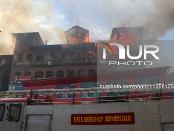 A house is engulfing in fire in a congested neighborhood in Old City Srinagar, Indian Administered Kashmir, on June 24, 2024. Several reside...