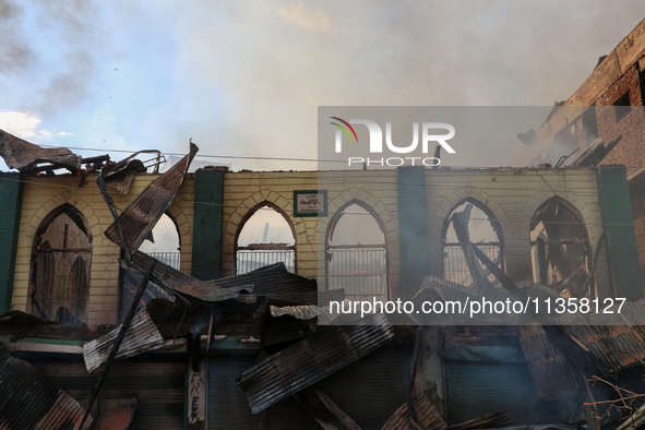 An old mosque is in shambles after a fire engulfed a congested neighborhood in Old City, Srinagar, Indian Administered Kashmir, on June 24,...