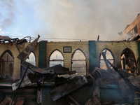 An old mosque is in shambles after a fire engulfed a congested neighborhood in Old City, Srinagar, Indian Administered Kashmir, on June 24,...