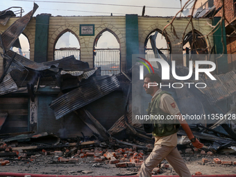 An old mosque is in shambles after a fire engulfed a congested neighborhood in Old City, Srinagar, Indian Administered Kashmir, on June 24,...