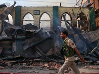 An old mosque is in shambles after a fire engulfed a congested neighborhood in Old City, Srinagar, Indian Administered Kashmir, on June 24,...