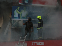 People are trying to douse the fire in a congested neighborhood in Old City Srinagar, Indian Administered Kashmir, on June 24, 2024. Several...