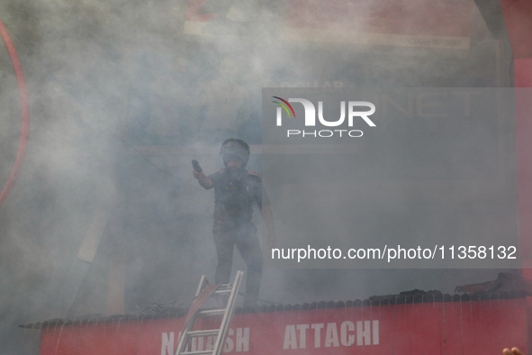 Firefighters are trying to contain the fire in a congested neighborhood in Old City Srinagar, Indian Administered Kashmir, on June 24, 2024....