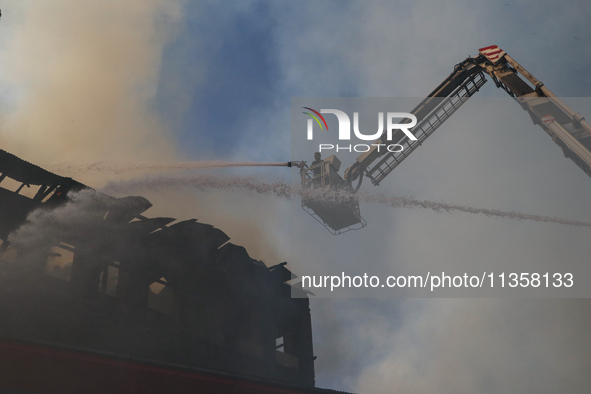 Firefighters are trying to douse the fire in a congested neighborhood in Old City Srinagar, Indian Administered Kashmir, on June 24, 2024. S...