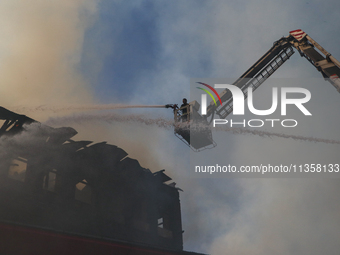 Firefighters are trying to douse the fire in a congested neighborhood in Old City Srinagar, Indian Administered Kashmir, on June 24, 2024. S...