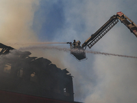 Firefighters are trying to douse the fire in a congested neighborhood in Old City Srinagar, Indian Administered Kashmir, on June 24, 2024. S...