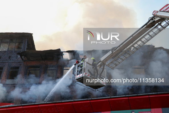 Firefighters are trying to douse the fire in a congested neighborhood in Old City Srinagar, Indian Administered Kashmir, on June 24, 2024. S...