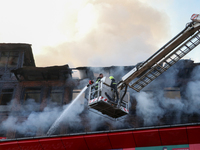 Firefighters are trying to douse the fire in a congested neighborhood in Old City Srinagar, Indian Administered Kashmir, on June 24, 2024. S...