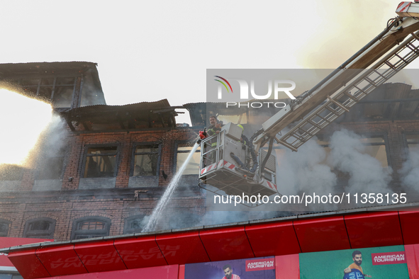 Firefighters are trying to douse the fire in a congested neighborhood in Old City Srinagar, Indian Administered Kashmir, on June 24, 2024. S...