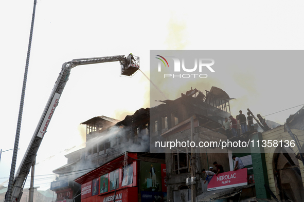 Firefighters are trying to douse the fire in a congested neighborhood in Old City Srinagar, Indian Administered Kashmir, on June 24, 2024. S...