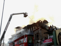 Firefighters are trying to douse the fire in a congested neighborhood in Old City Srinagar, Indian Administered Kashmir, on June 24, 2024. S...