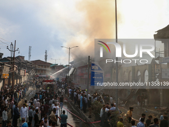 Firefighters are trying to douse the fire in a congested neighborhood in Old City Srinagar, Indian Administered Kashmir, on June 24, 2024. S...