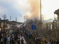 Firefighters are trying to douse the fire in a congested neighborhood in Old City Srinagar, Indian Administered Kashmir, on June 24, 2024. S...