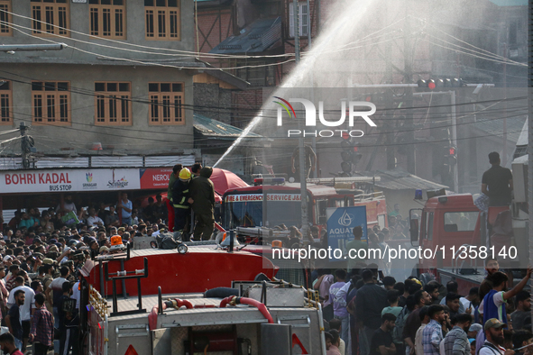 Firefighters are trying to douse the fire in a congested neighborhood in Old City Srinagar, Indian Administered Kashmir, on June 24, 2024. S...