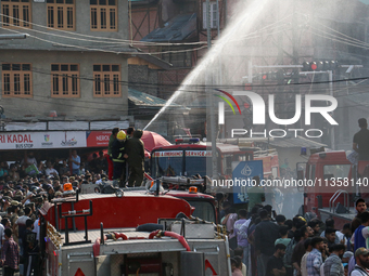 Firefighters are trying to douse the fire in a congested neighborhood in Old City Srinagar, Indian Administered Kashmir, on June 24, 2024. S...