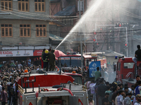 Firefighters are trying to douse the fire in a congested neighborhood in Old City Srinagar, Indian Administered Kashmir, on June 24, 2024. S...