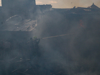 Firefighters are trying to douse the fire in a congested neighborhood in Old City Srinagar, Indian Administered Kashmir, on June 24, 2024. S...