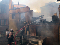 People are trying to douse the fire in a congested neighborhood in Old City Srinagar, Indian Administered Kashmir, on June 24, 2024. Several...