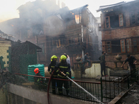 Firefighters are trying to douse the fire in a congested neighborhood in Old City Srinagar, Indian Administered Kashmir, on June 24, 2024. S...