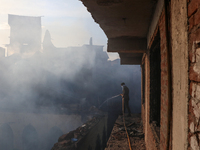 People are trying to douse the fire in a congested neighborhood in Old City Srinagar, Indian Administered Kashmir, on June 24, 2024. Several...