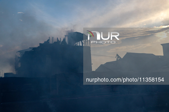 Firefighters are trying to douse the fire in a congested neighborhood in Old City Srinagar, Indian Administered Kashmir, on June 24, 2024. S...